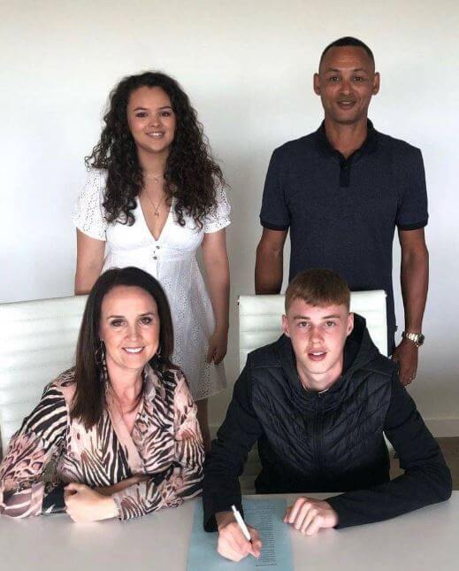 Marie Palmer with her husband Jermaine and daughter when Cole Palmer signed his first professional contract with Manchester City.
